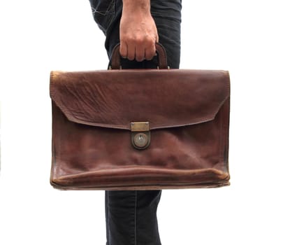 man holding an old leather bag