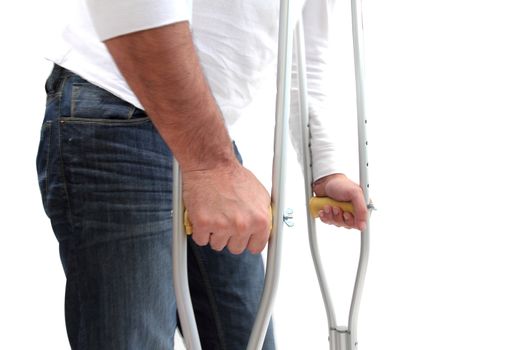 closeup of a man walking with crutches