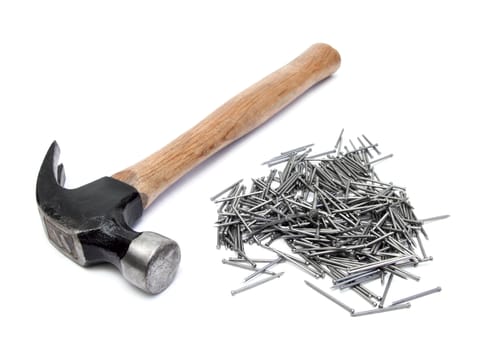hand hammer with pile of nails over white