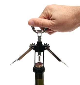 closeup of hand opening a bottle of wine with opener over white