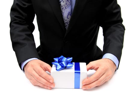 closeup of a man in a suit offering a present