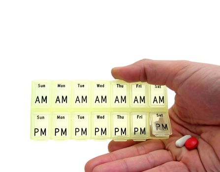 closeup of a hand holding a pills dispenser box