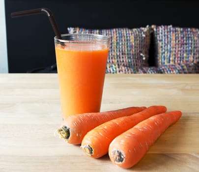 Fresh Carrot juice on wood