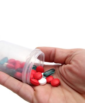 pillbox with red white and blue pills in a hand