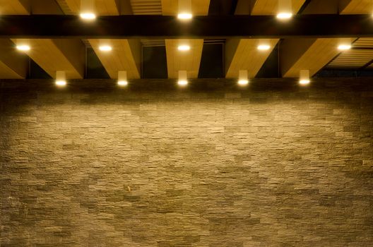 Stone wall background with lighting spots