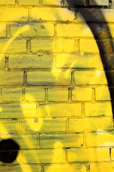 closeup of a painted yellow brick wall