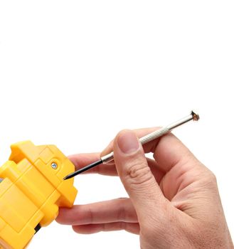 closeup of a hand holding a little screwdriver