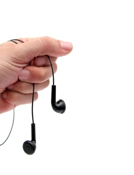 closeup of a hand holding earphones over white