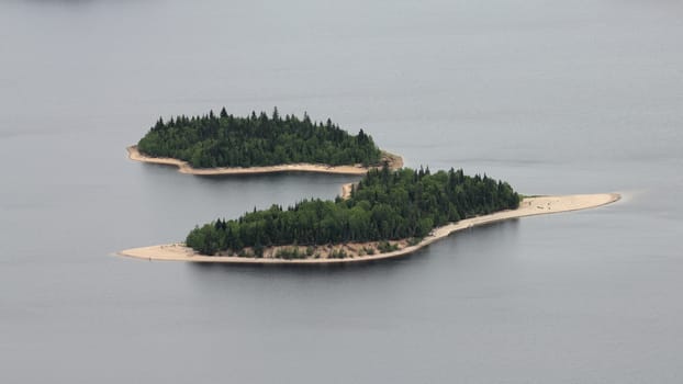 two wild islands on a lake taken from a plane