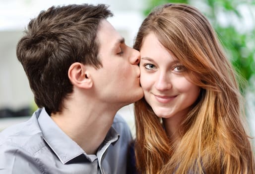 Handsome young man embracing his girlfriend with love