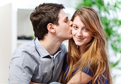 Handsome young man embracing his girlfriend with love