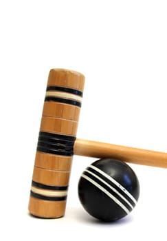 croquet mallet and ball over white
