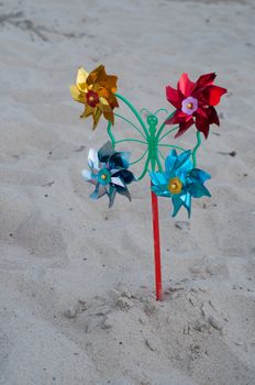 Shot of pinwheel toy on the sandy background