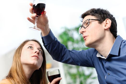 Very beautiful young couple toasting wine glasses