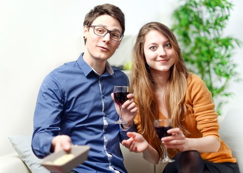 Very beautiful young couple toasting wine glasses