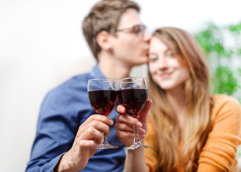 Very beautiful young couple toasting wine glasses