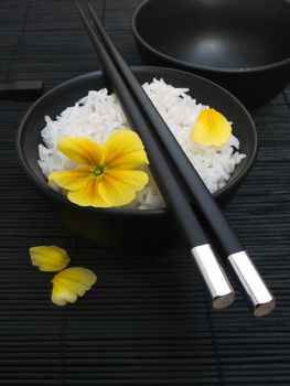 asian rice with yellow flower and chopsticks