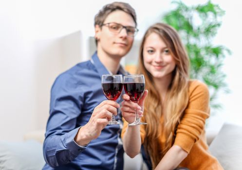 Very beautiful young couple toasting wine glasses