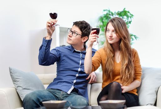 Very beautiful young couple toasting wine glasses