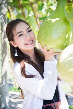 A smile of happy asian woman with calabash vegetable