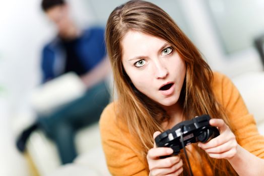 Portrait of beautiful woman playing videogame at home