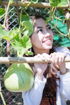 A smile of happy asian woman with calabash vegetable