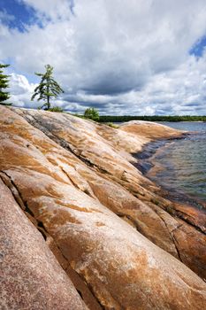 Smooth rocky lake shore of Georgian Bay in Killbear provincial park near Parry Sound, Ontario, Canada.