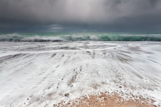 ocean waveson sand beach during storm, Etretat, France