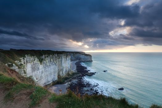 stormy clouded sky over cliffs in ocean, Etretat, France