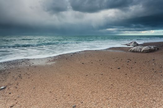 stormy sky over rock beach in Atlantic ocean, Normandy, France