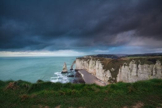 dark storm sky over rocks in Atlantic ocean, Etretat, Normandy, France
