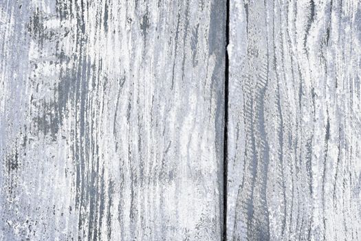 Textured background of distressed rustic wood with peeling blue and white paint