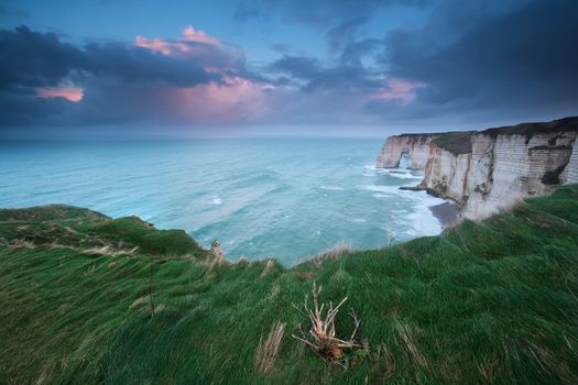 stormy sunrise over cliffs in Atlantic ocean, Etretat, France