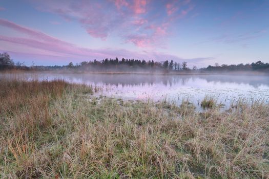 sunrise over lake in cold autumn morning, Friesland, Netherlands