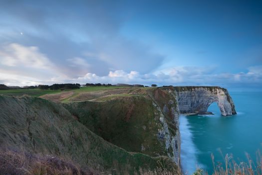 cliffs and Atlantic ocean in dusk, Etretat, France