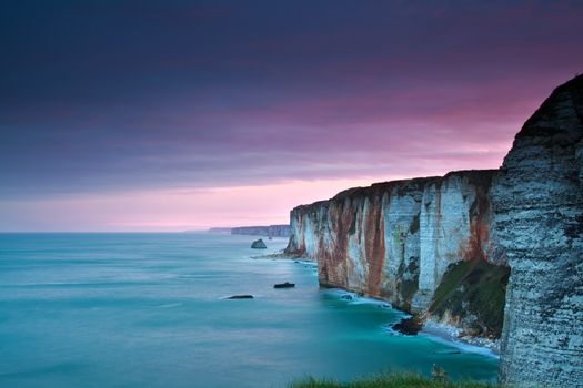 purple sunrise over Atlantic ocean and cliffs, Normandy, France