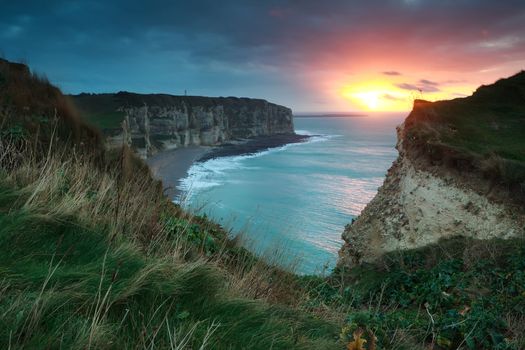 dramatic purple sunset over Atlantic ocean, Etretat, Normandy, France