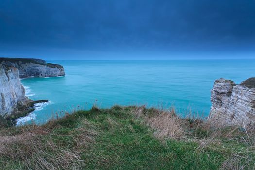 cliffs in ocean in dusk, Etretat, France