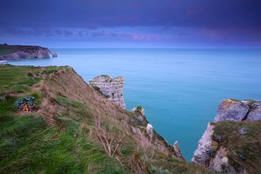 cliffs in Atlantic ocean at sunrise, Etretat, France