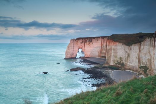 evening sunlight on cliffs in ocean, Etretat, France