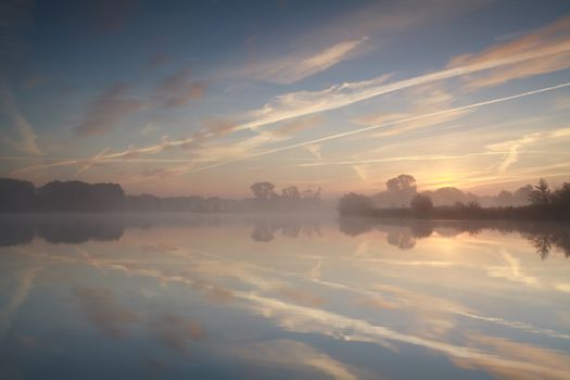 misty sunrise on wild lake, Drenthe, Netherlands
