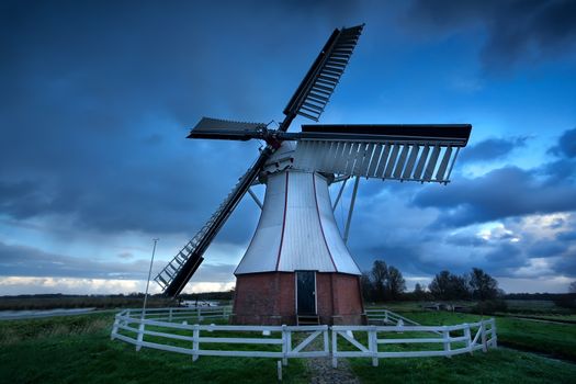 Dutch windmill over storm sky, Holland