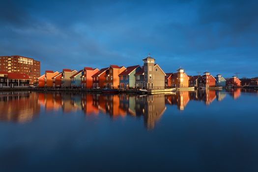 multicolor buildings on water in sunshine, Groningen, Netherlands