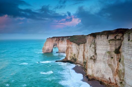 rocky cliff in azure ocean waves, Etretat, Normandie, France