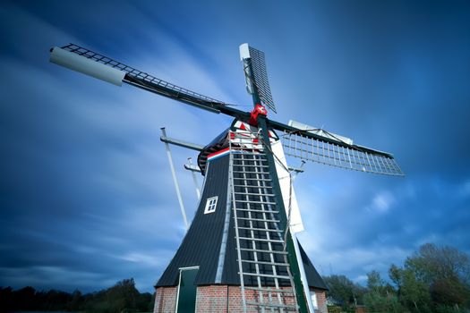 Dutch windmill over sky with long exposure, Holland