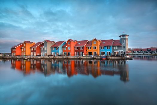 colorful buildings on water  at sunrise, Groningen, Netherlands