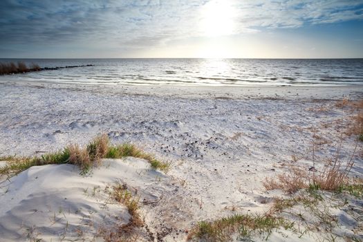 sunshine over sand beach and North sea, Netherlands