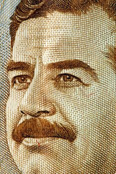 A close up saddam hussein on an iraqi dinar