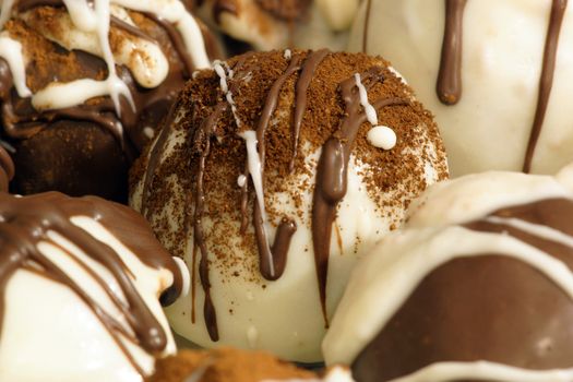 A white chocolate covered truffle drizzled with milk chocolate