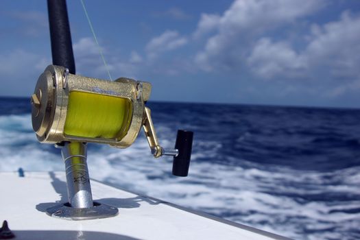A bronze fishing reel and rod setup at sea